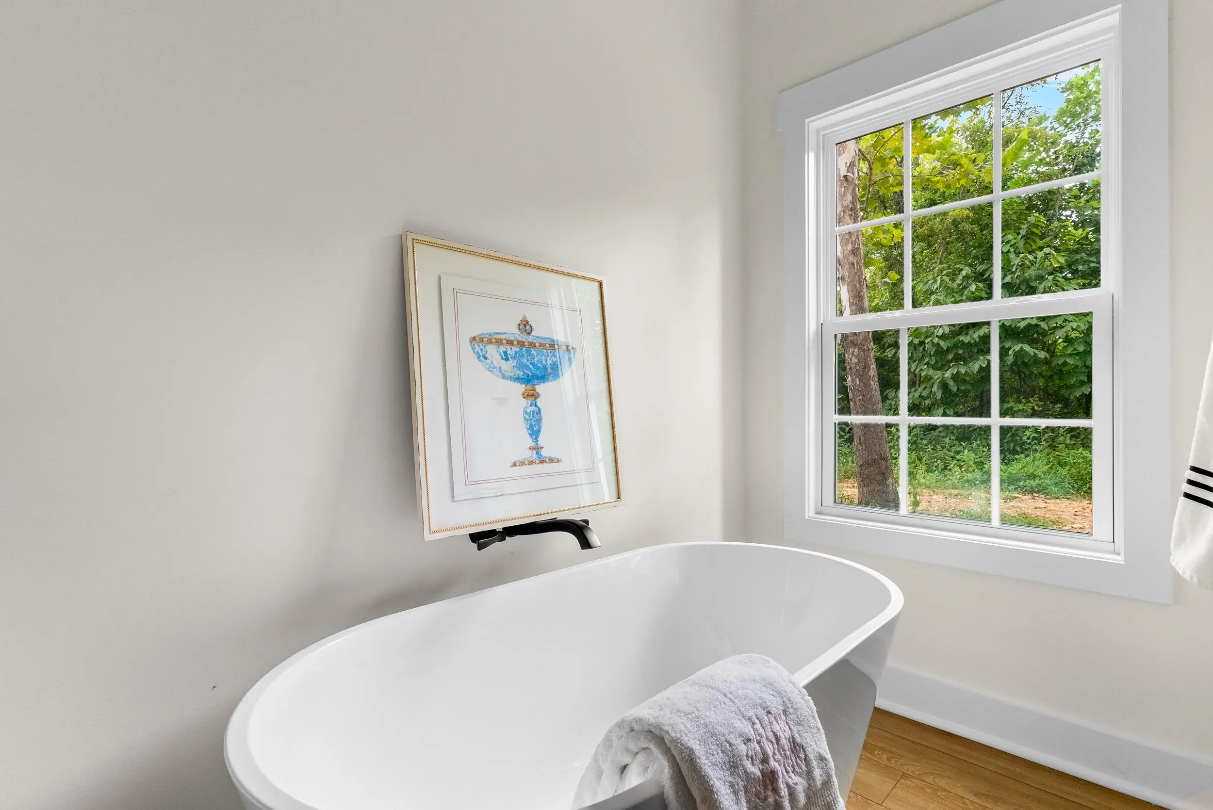 Picture over a standing tub in a bathroom.