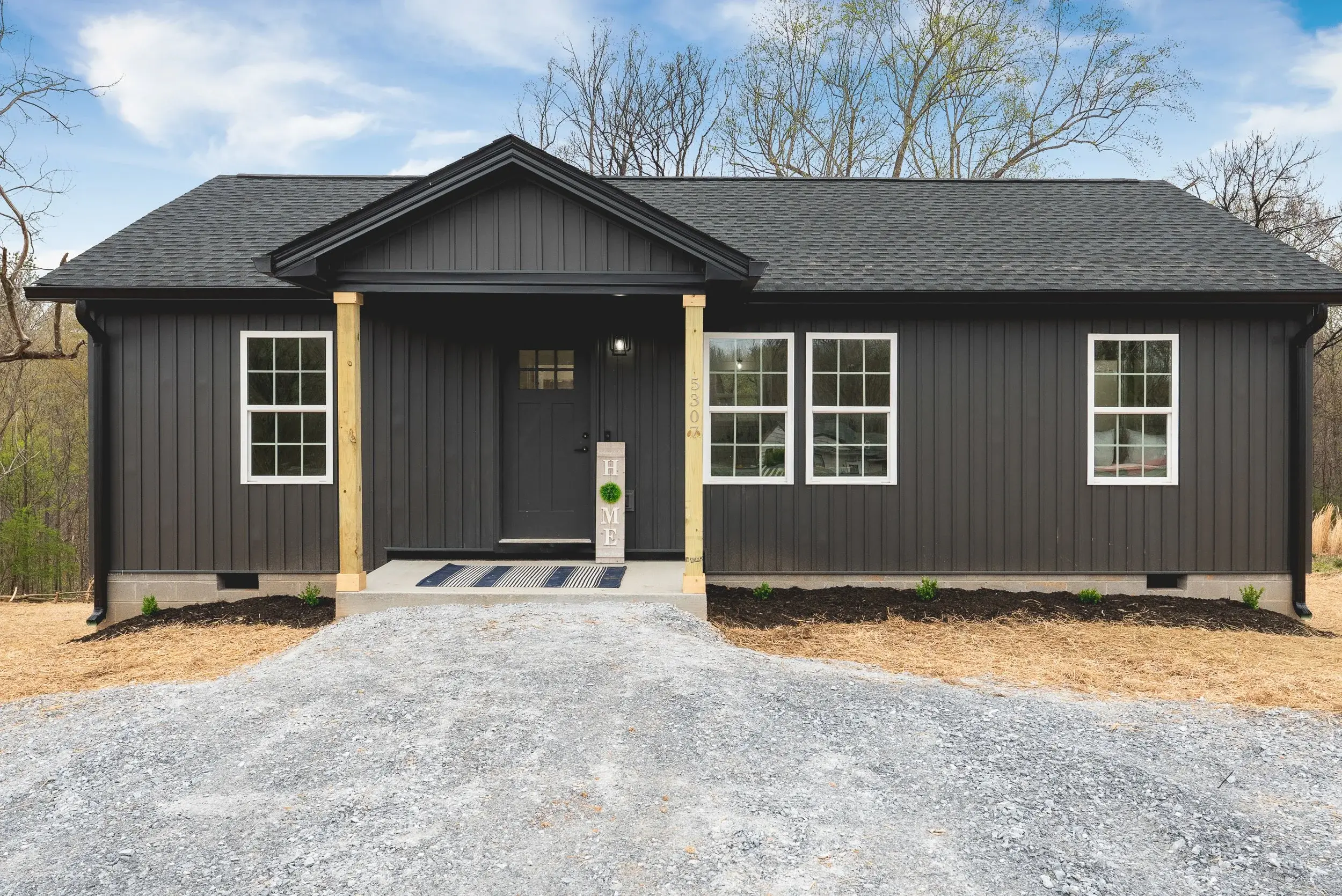Front view of the heritage home plan with gravel driveway